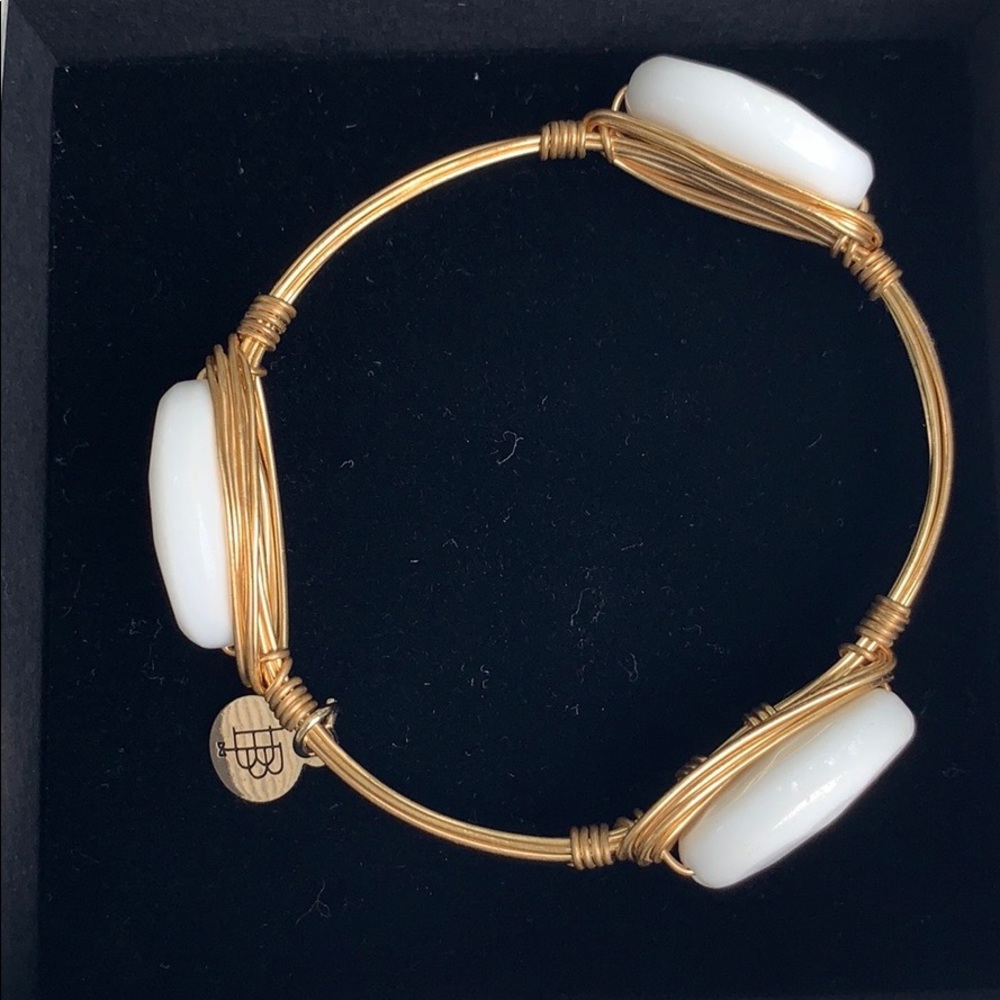 B. b. Lila gold and white dangle bracelet